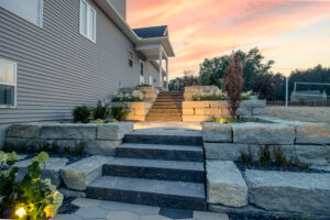 stone staircase in backyard with lake